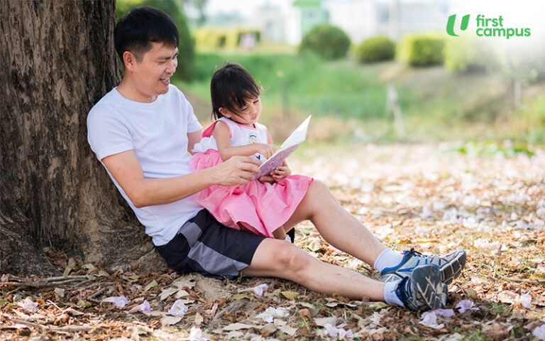 A Father is Reading A Book With Her Daughter