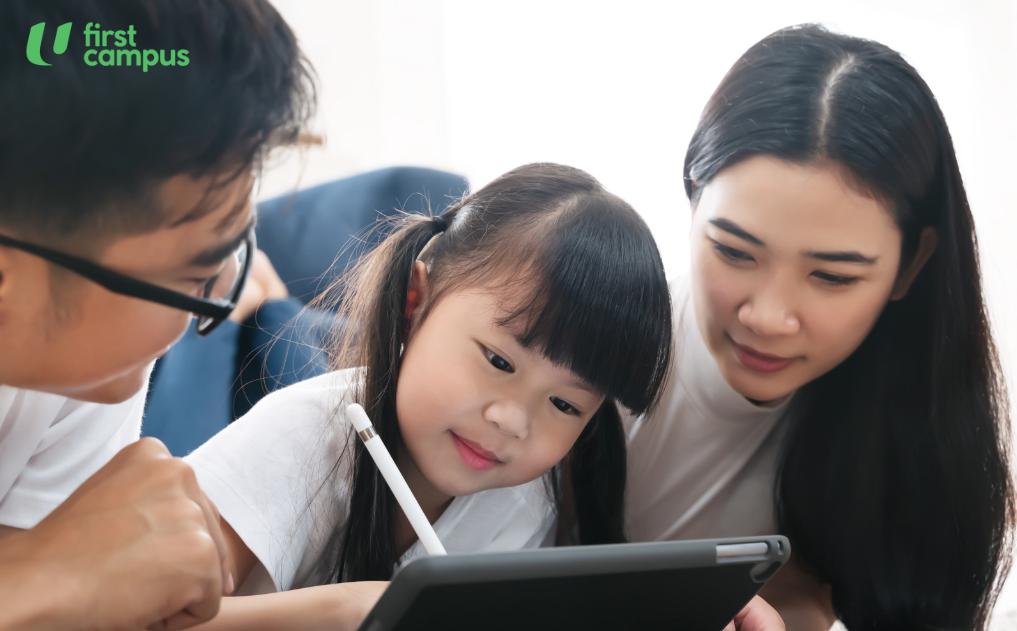 Parents using tablet with young preschool child, choosing quality content together