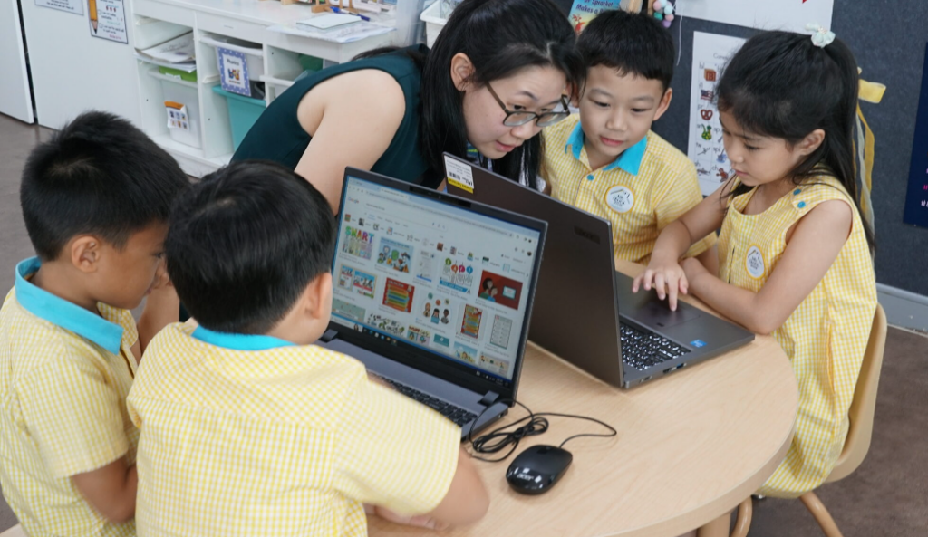 A Little Skool-House teacher supervises four preschool children while they learn to cultivate digital intelligence. 