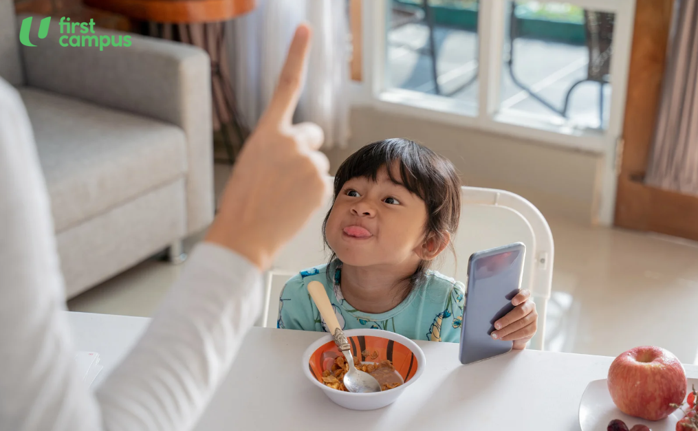 Young girl throwing a tantrum as parent tells her she has to limit her screen time